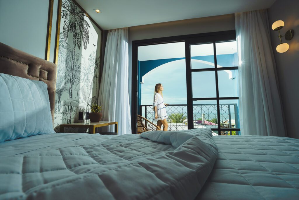 Woman enjoying the ocean view in a suite at Exotica Boutique Hotel