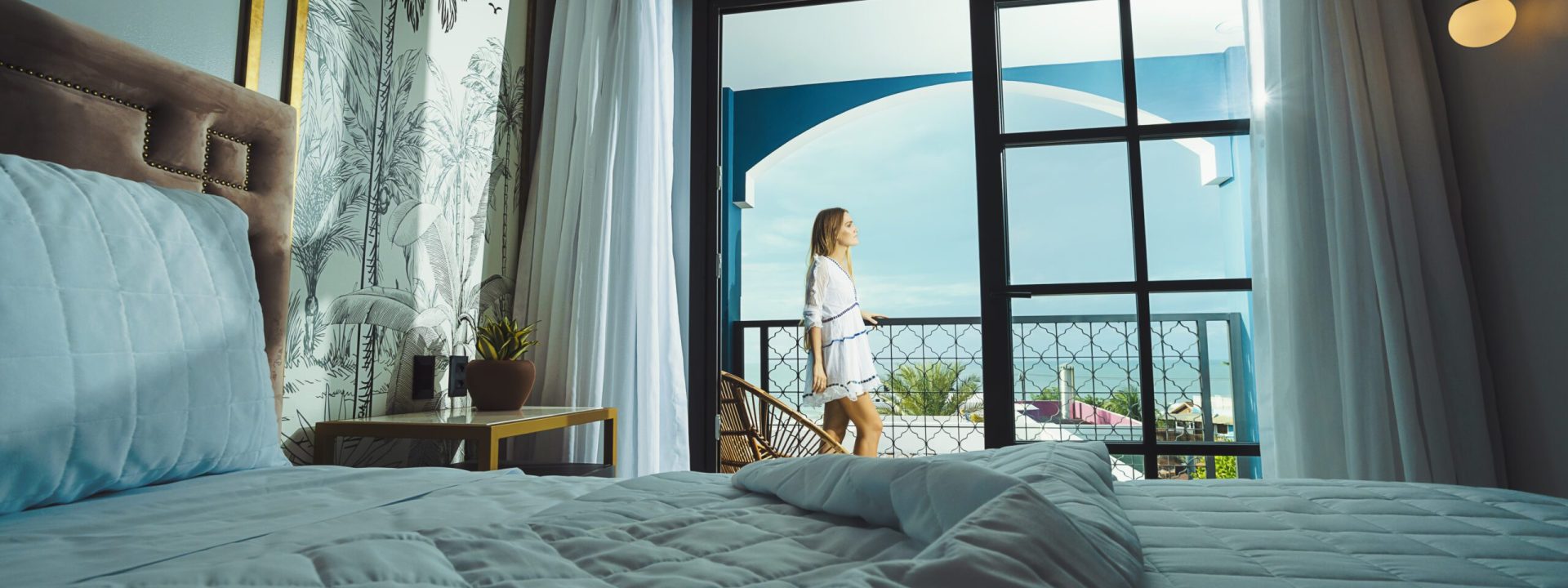 Woman enjoying the ocean view in a suite at Exotica Boutique Hotel